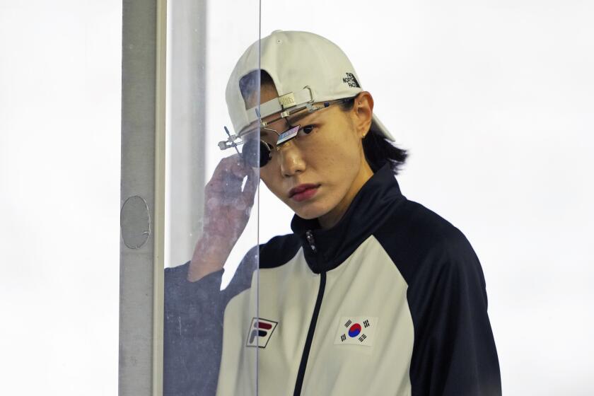 South Korea's Kim Yeji prepares to compete in the 25m pistol precision women's qualification round at the 2024 Summer Olympics, Friday, Aug. 2, 2024, in Chateauroux, France. (AP Photo/Manish Swarup)