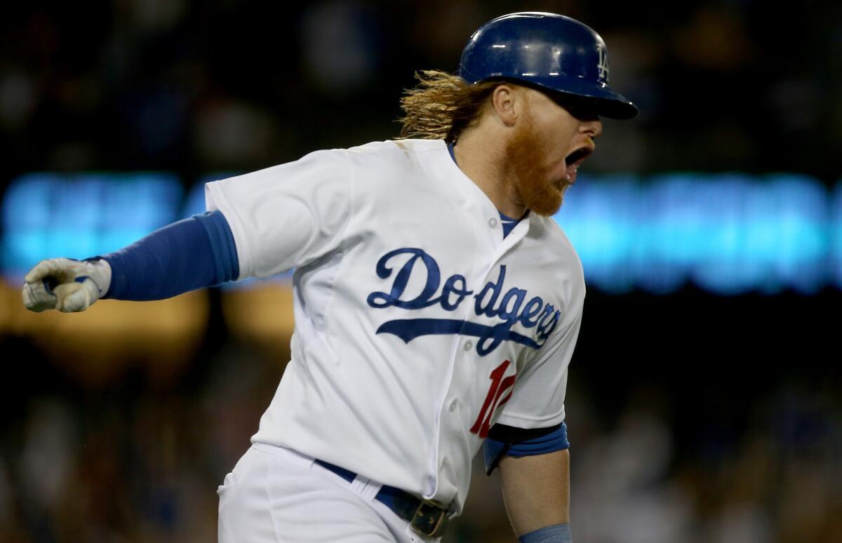 Justin Turner celebrates after hitting a two-run home run in the eighth inning to give the Dodgers a 2-1 lead over the Padres.