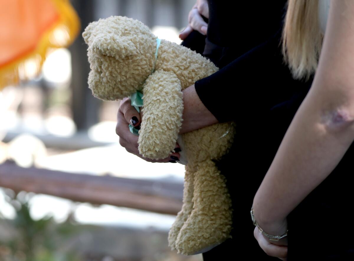 Joanna Cloonan, mother of Costa Mesa 6-year-old Aiden Leos, holds a teddy bear.