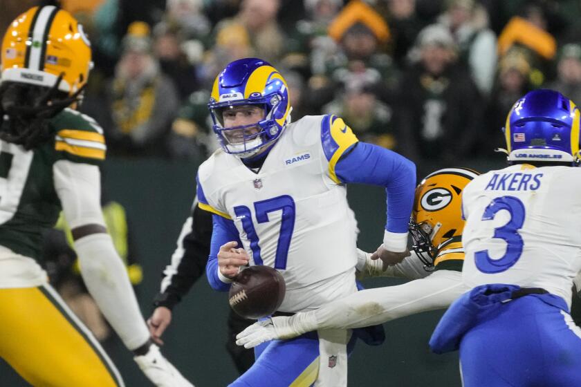 Los angles Rams quarterback Baker Mayfield (17) fumbles as he's hit by Green Bay Packers.