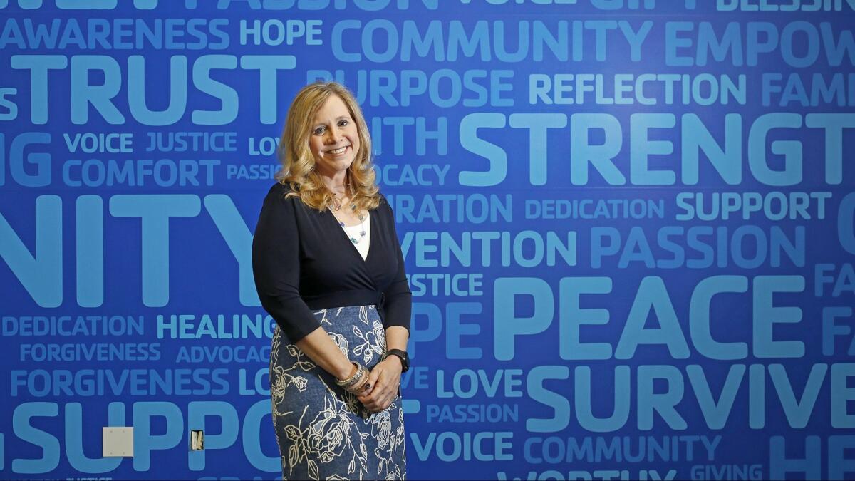 Founder Patricia Wenskunas poses for a portrait in front of a wall decorated with positive words at Crime Survivors in Santa Ana. Wenskunas started the nonprofit organization after suffering from a violent crime 16 years ago.