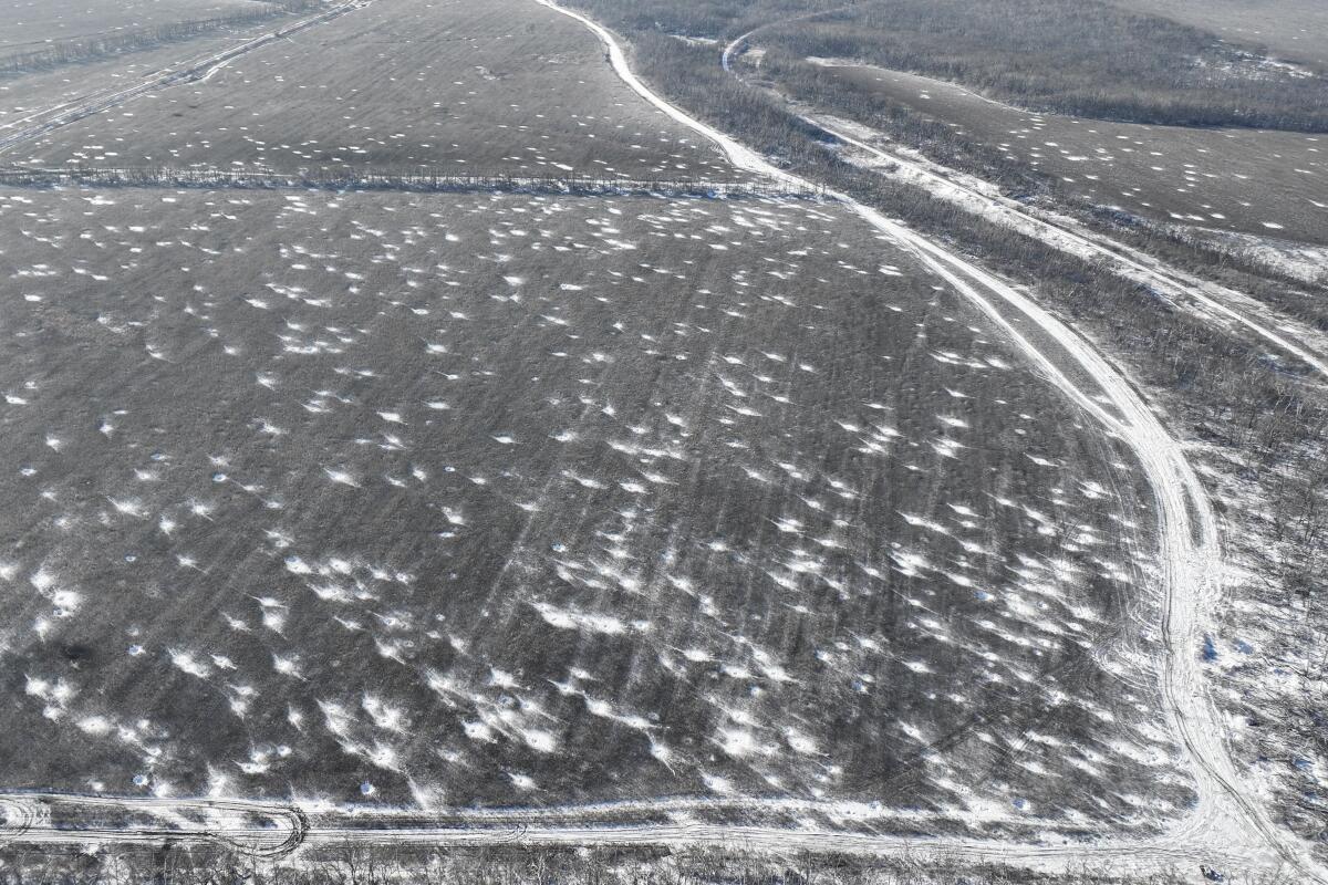 Multiple craters left by shelling in a field in Ukraine's Donetsk region
