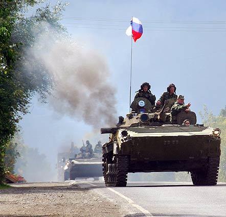 Russian peacekeeping soldiers drive military vehicles out of the Kventakosa checkpoint. Russia and the EU took a key step toward resuming partnership talks after President Dmitry Medvedev pledged his troops would complete their pullout from buffer zones in Georgia.