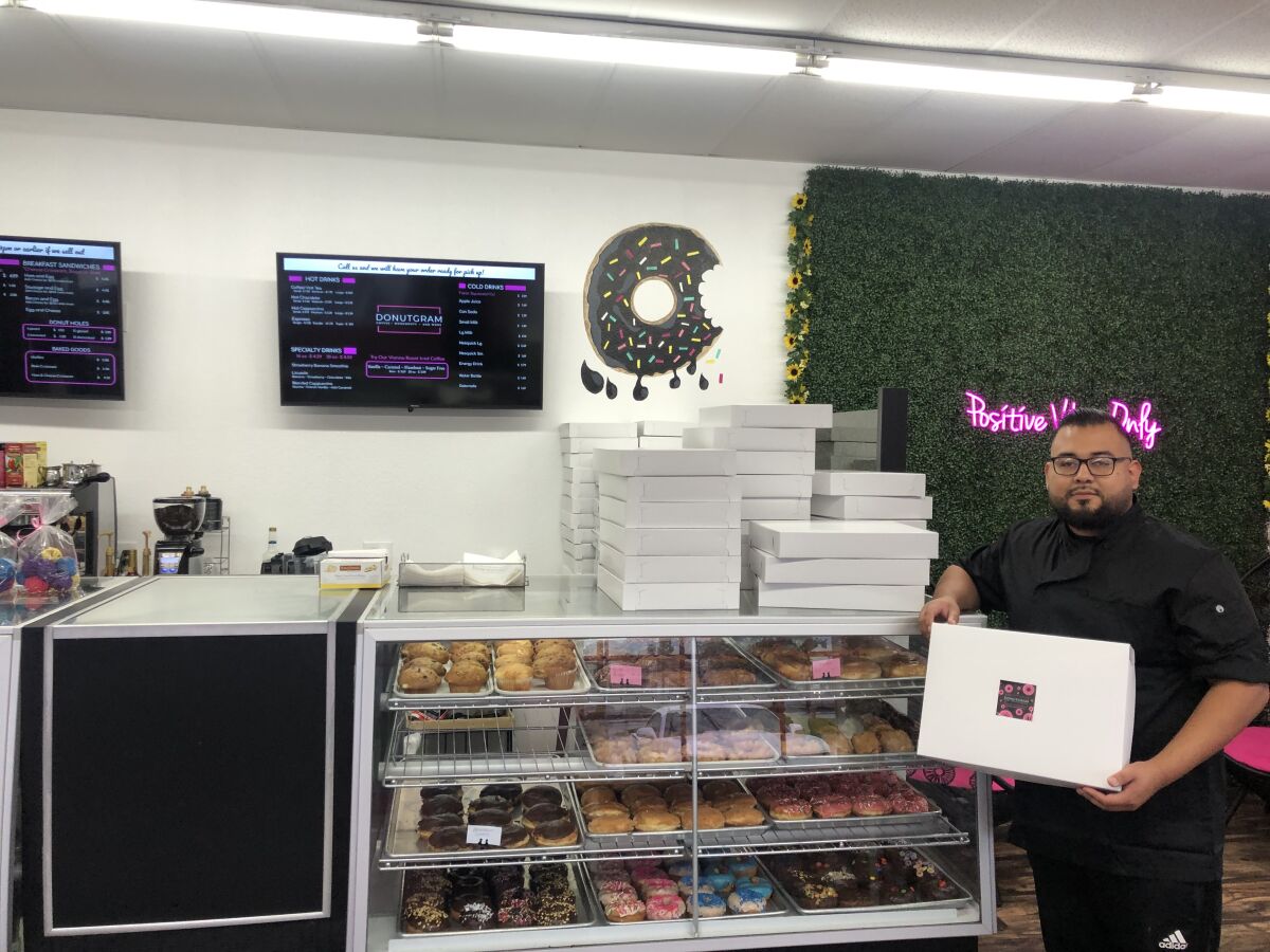 Baker Francisco Guevera inside newly opened Donutgram doughtnut shop in Escondido, which he owns with his mom, Virginia, and sister, Mitzi.