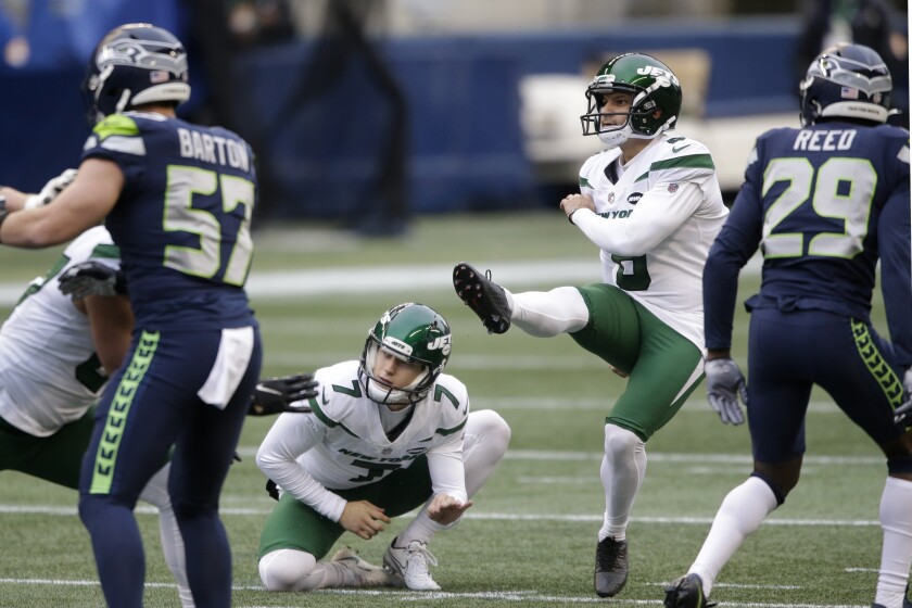 New York Jets kicker Sergio Castillo, second from right, kicks a field goal as Braden Mann (7) holds during the first half of an NFL football game against the Seattle Seahawks, Sunday, Dec. 13, 2020, in Seattle. (AP Photo/Lindsey Wasson)