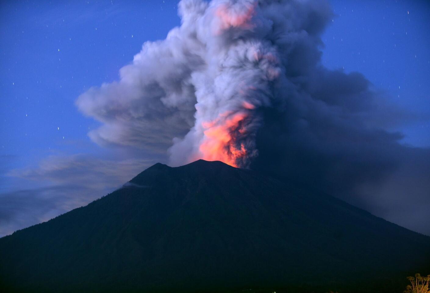 Mt. Agung erupts at night. Indonesian authorities extended the closure of the international airport on the resort island of Bali for a second day.