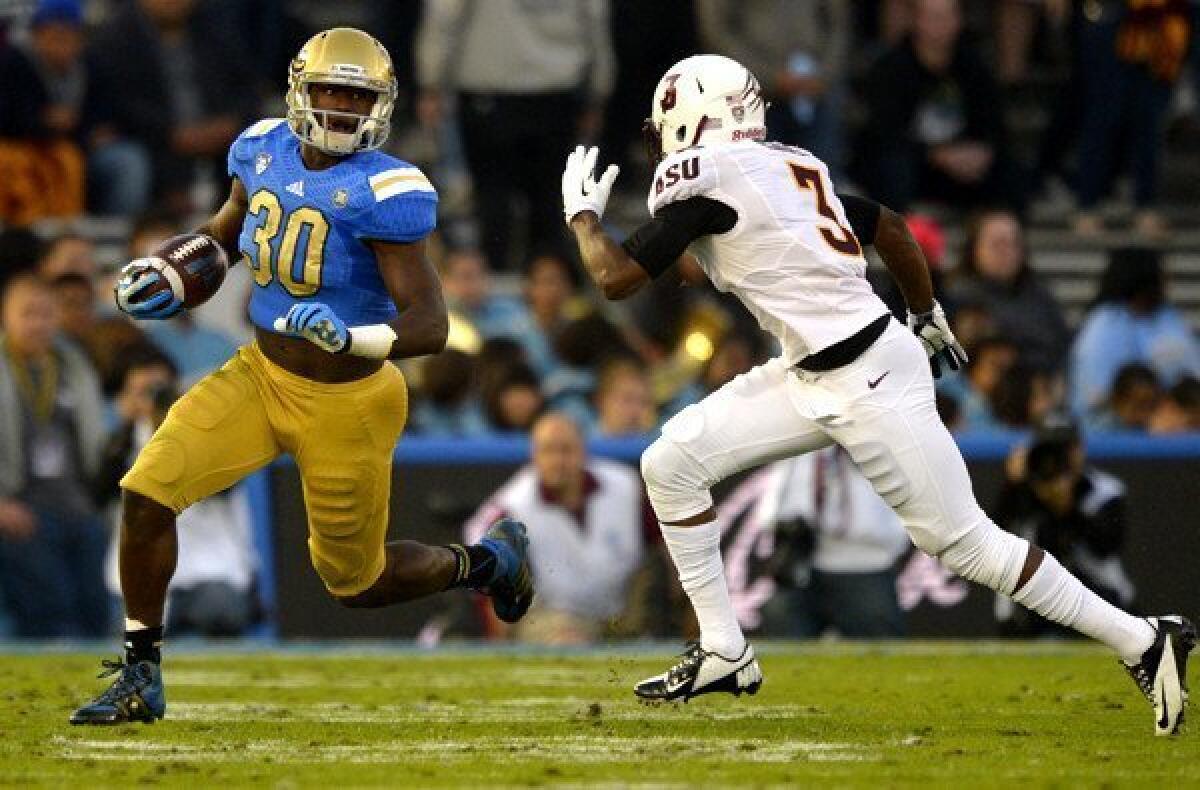 UCLA's Myles Jack tries to turn the corner on Arizona State defensive back Damarious Randall in the first half Saturday at the Rose Bowl.