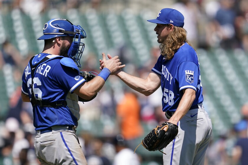 Kansas City Royals catcher Cam Gallagher (36) and relief pitcher Scott Barlow (58) celebrate after the final out in the ninth inning of a baseball game against the Detroit Tigers in Detroit, Sunday, July 3, 2022. (AP Photo/Paul Sancya)
