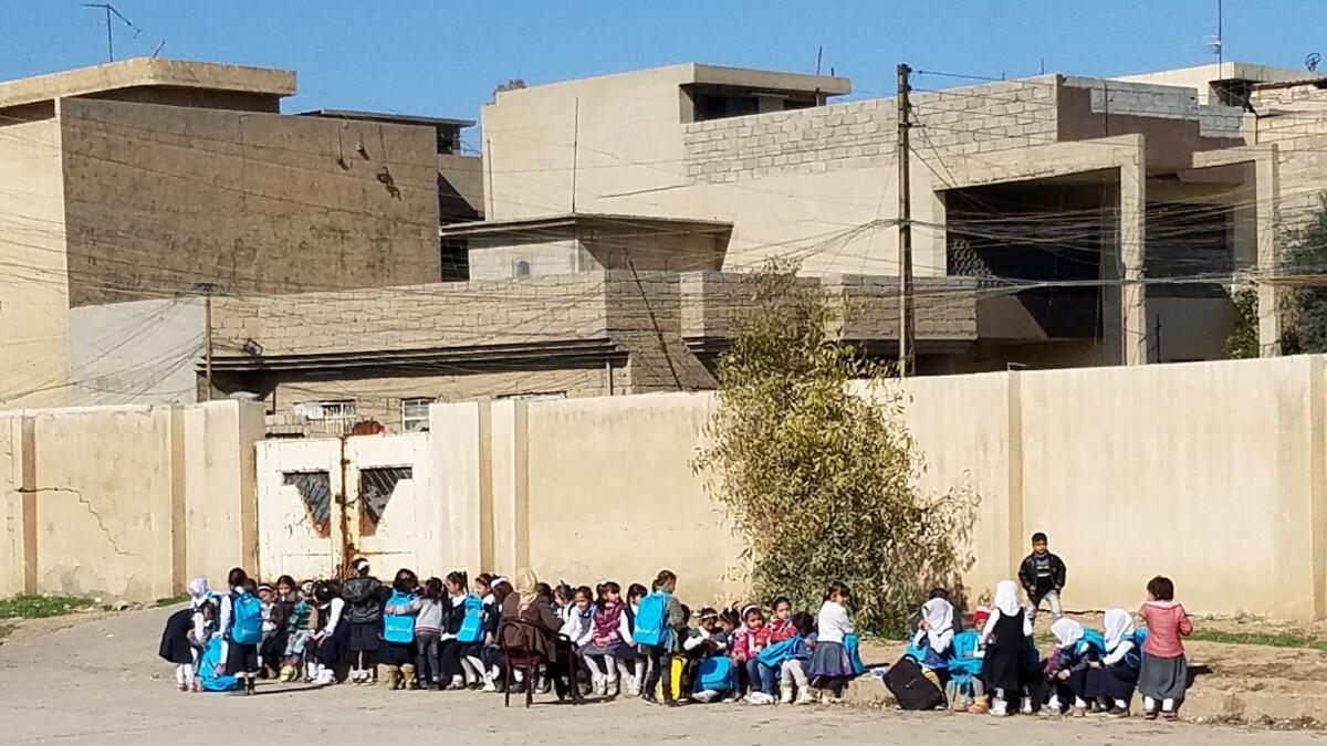 Children outside Al Akhaa school in Mosul, Iraq. The school closed temporarily in October and reopened Jan. 22 after Islamic State was routed from the east side.