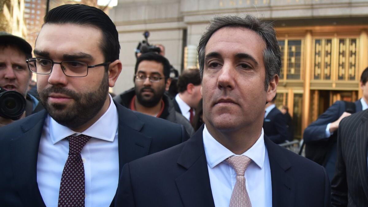 Michael Cohen, right, leaves the U.S. Courthouse in New York on April 26.