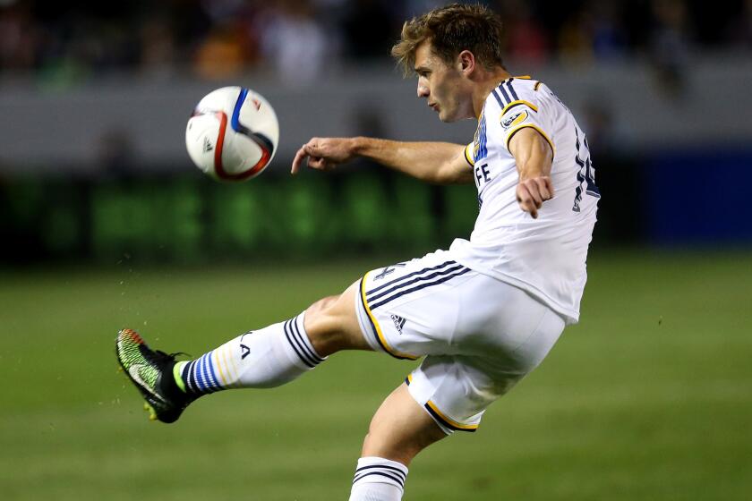Galaxy midfielder Robbie Rogers clears the ball during a game against the Chicago Fire.
