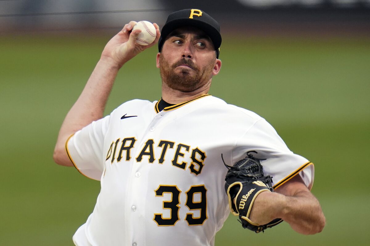 Pittsburgh Pirates starting pitcher Zach Thompson delivers during the first inning of the team's baseball game against the Cincinnati Reds in Pittsburgh, Saturday, May 14, 2022. (AP Photo/Gene J. Puskar)