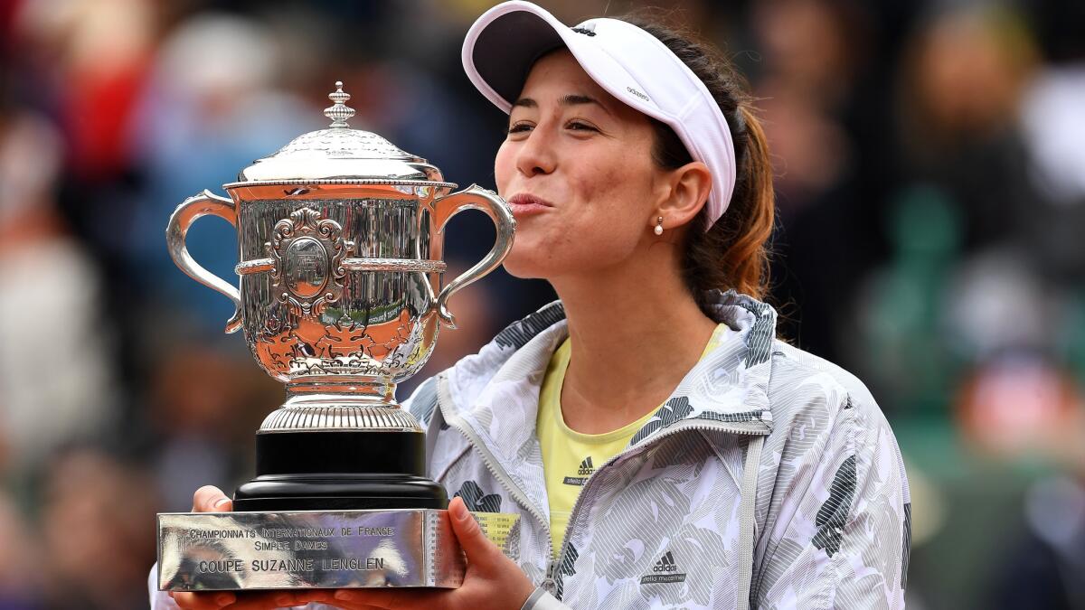 Garbine Muguruza kisses the winner's trophy after defeating Serena Williams in the French Open final on Saturday.