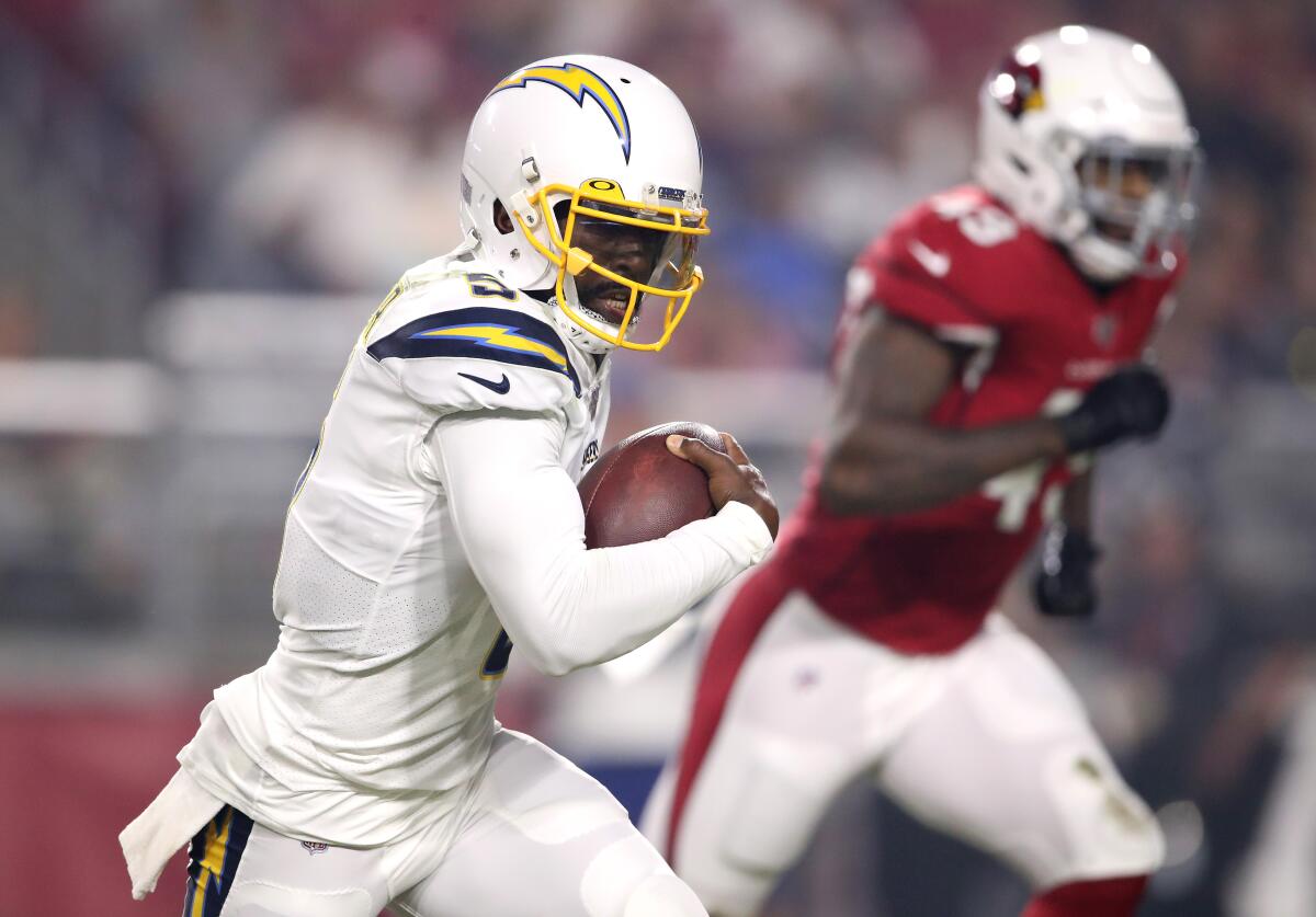 Chargers quarterback Tyrod Taylor runs with the ball during a preseason game against the Cardinals on Aug. 8, 2019, at State Farm Stadium.