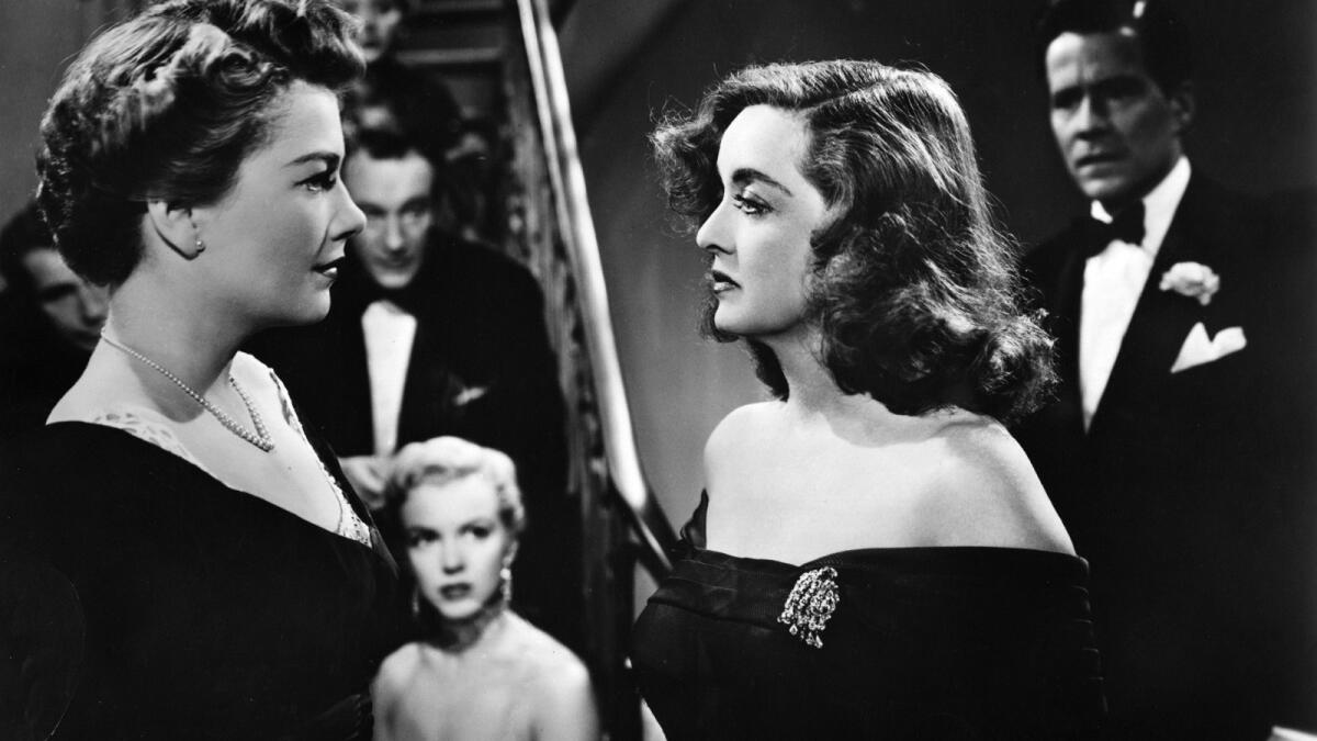 Anne Baxter, left, and Bette Davis in "All About Eve." That's Marilyn Monroe in the background.