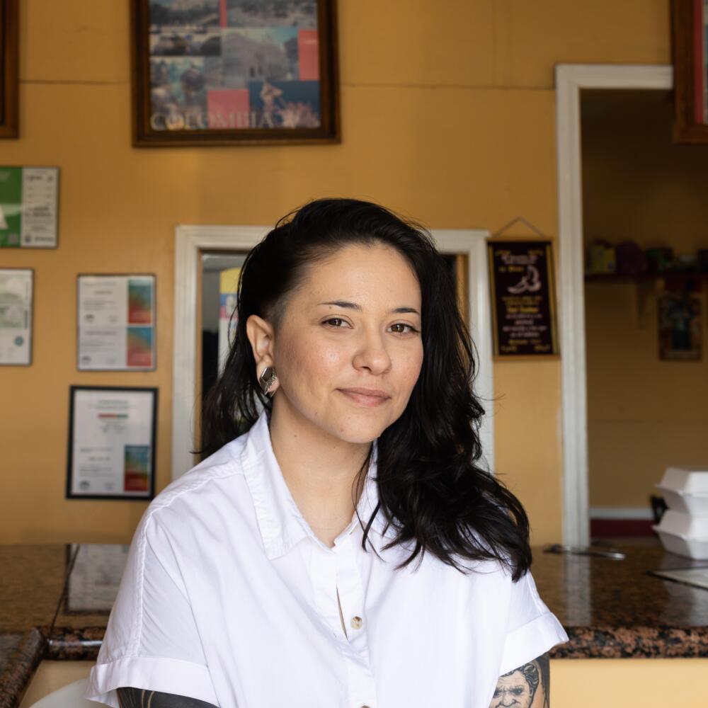 Gisselle Palomera sits inside a restaurant 