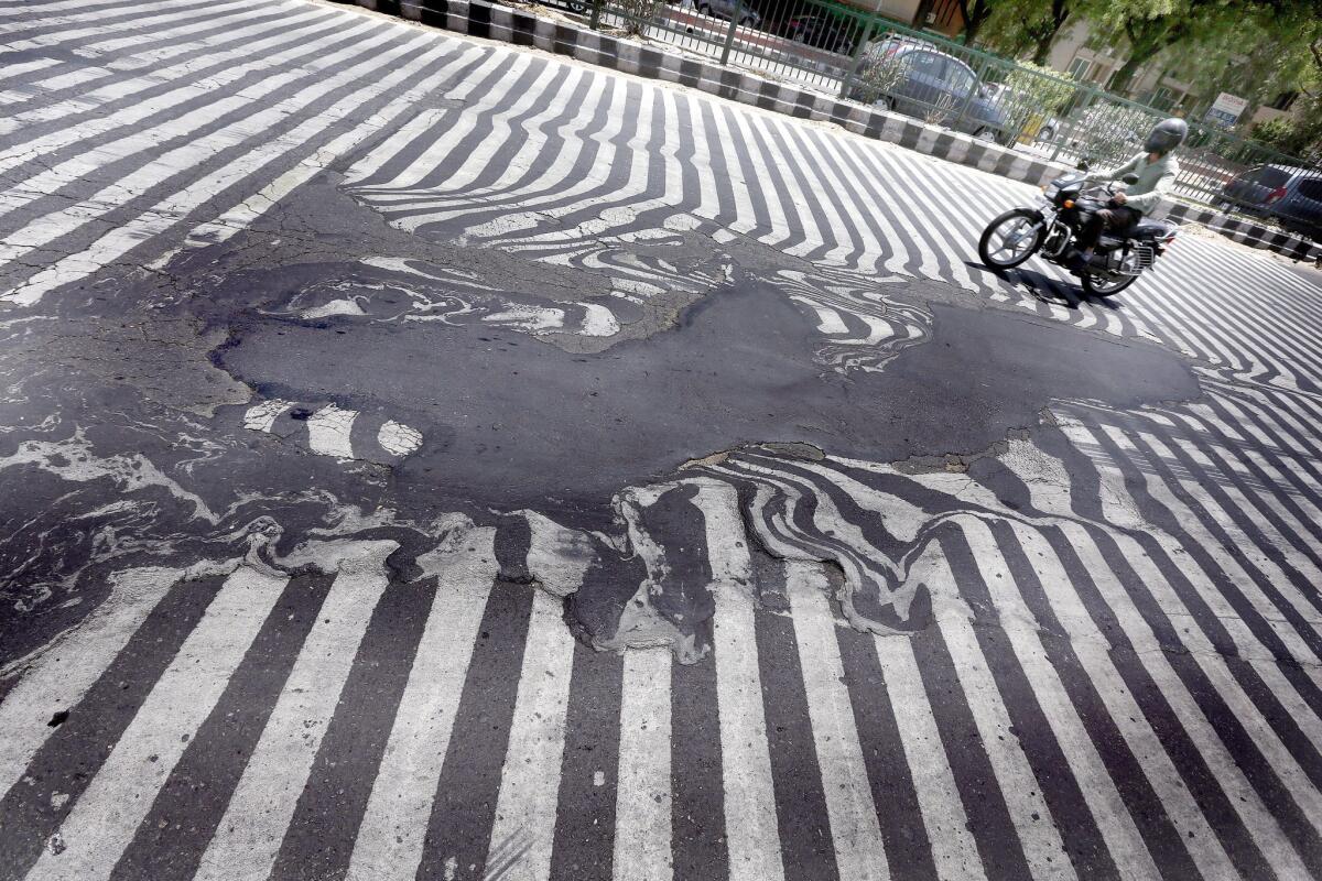 Road markings melt along with the asphalt due to high temperatures in New Delhi.
