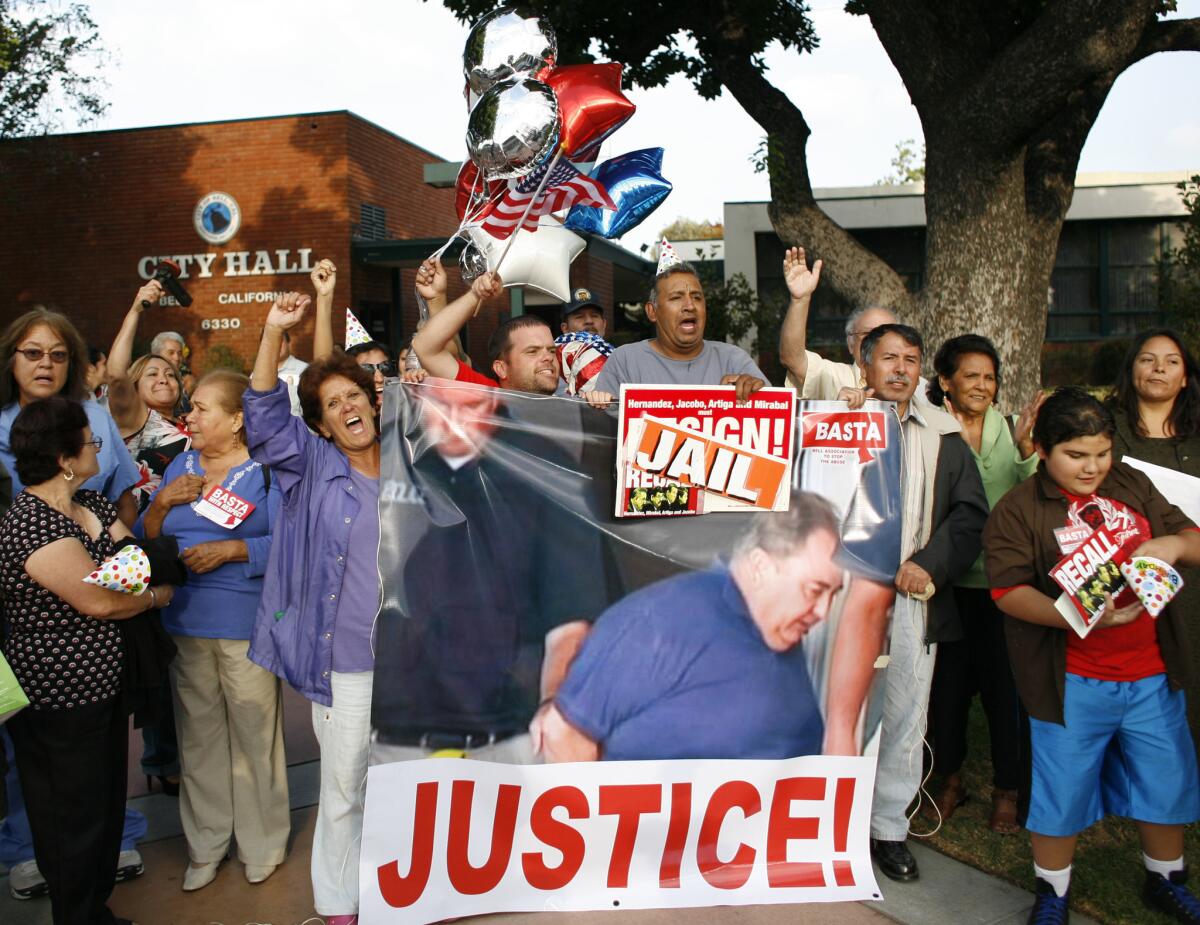 Outside City Hall, Bell residents display a banner celebrating the arrest of City Administrator Robert Rizzo.