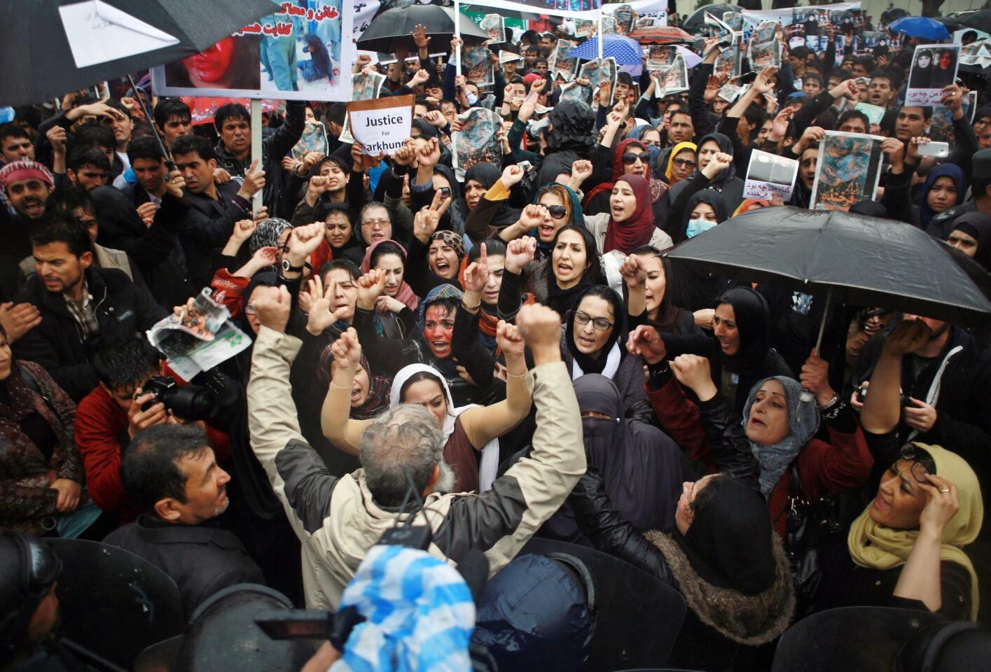 Afghans crowd in front of the Supreme Court in the capital Kabul to protest the killing of a woman who was beaten a burned to death by a mob last week.