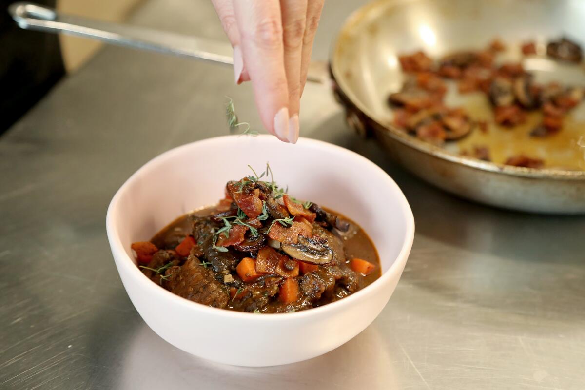 Thyme species are sprinkled atop a bowl of beef bourguignon at Taylor Made Cuisine.