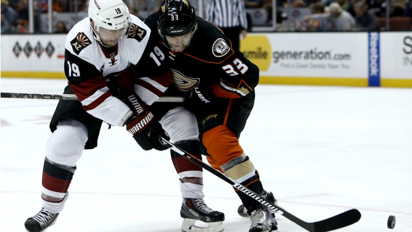 Ducks right wing Jakob Silfverberg (33) battles Coyotes right wing Shane Doan (19) for possession of the puck in the first period Wednesday night in Anaheim.