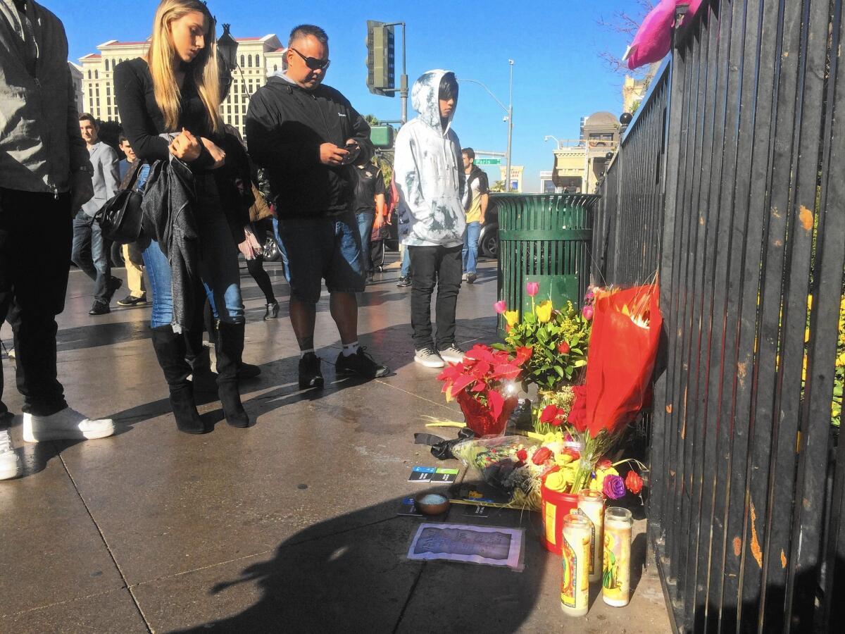 People visit a makeshift memorial on the Las Vegas Strip on Dec. 22, two days after a car plowed into crowds of pedestrians.