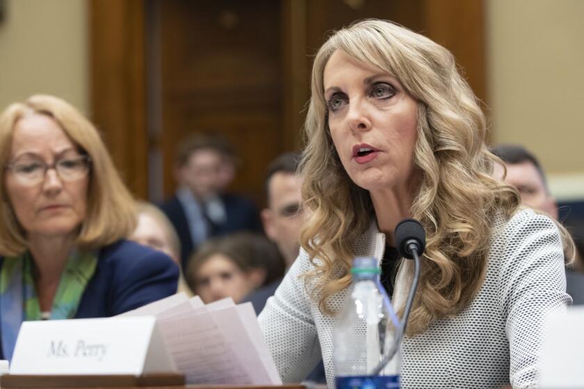 USA Gymnastics President and CEO Kerry Perry, center, joined at left by U.S. Olympic Committee Acting CEO Susanne Lyons, testifies before the House Commerce Oversight and Investigations Subcommittee about the Olympic community's ability to protect athletes from sexual abuse, on Capitol Hill in Washington, Wednesday, May 23, 2018. (AP Photo/J. Scott Applewhite)