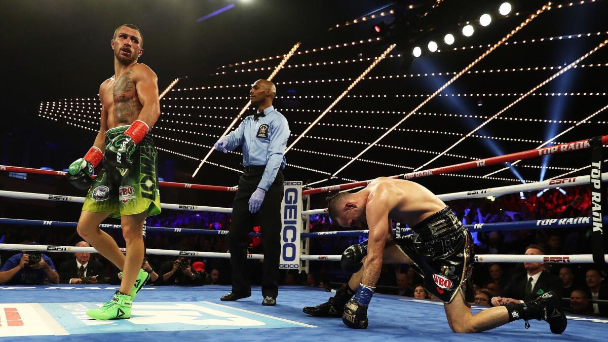 Vasiliy Lomachenko knocks down Jose Pedraza in the eleventh round during their WBA/WBO lightweight unification bout.