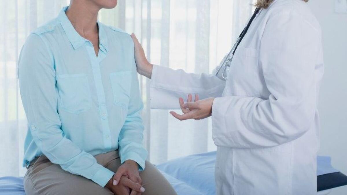 A patient and her doctor speak during a check-up.