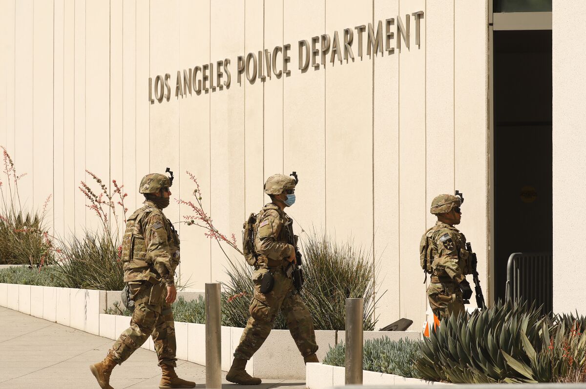 National Guardsmen patrol outside the Los Angeles Police Department headquarters in downtown L.A.