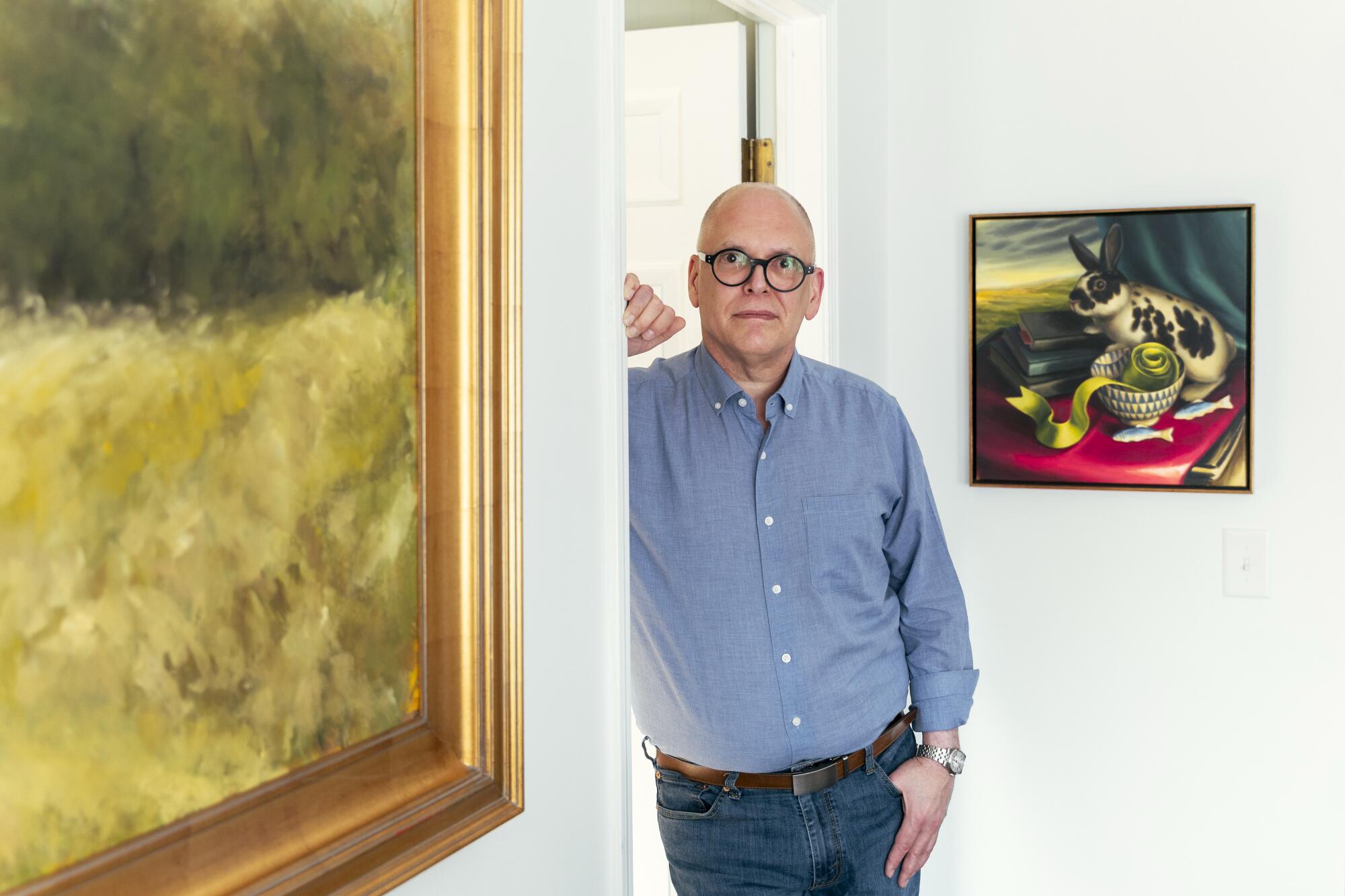 a man stands in a doorway posing for a formal portrait