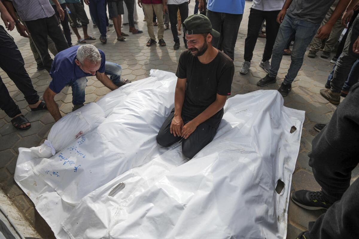 Palestinians mourn their relatives killed in an Israeli bombardment on a residential building.