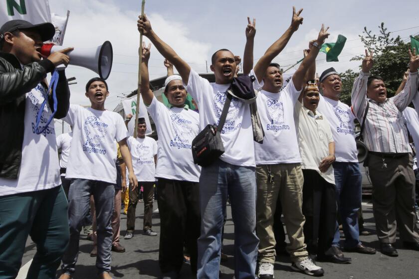 Filipino Muslims rally in Manila on Wednesday in support of a bill to grant autonomy to a Muslim region in the south, to be called Bangsamoro, or Moro Nation.