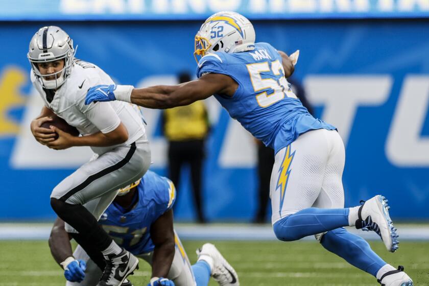 Chargers linebacker Khalil Mack closes for a sack of Raiders quarterback Aidan O'Connell.