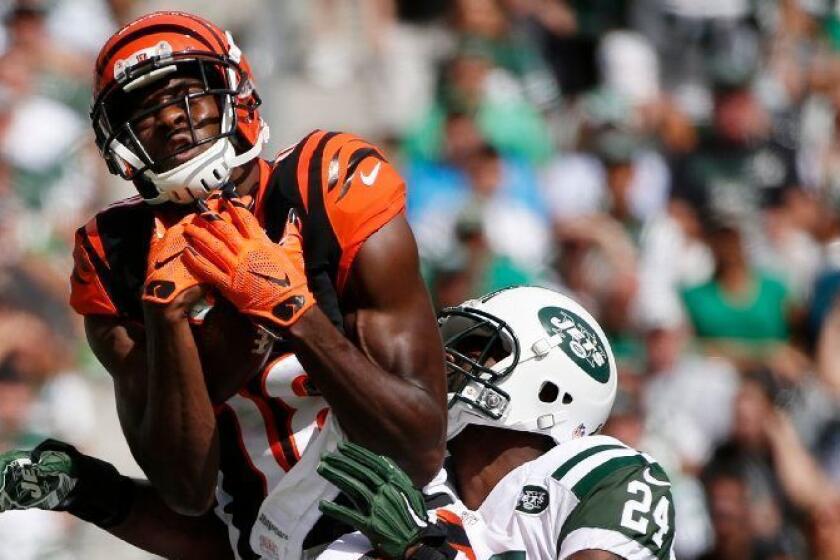 Bengals receiver A.J. Green catches a pass in front of Jets cornerback Darrelle Revis during a game on Sept. 11.