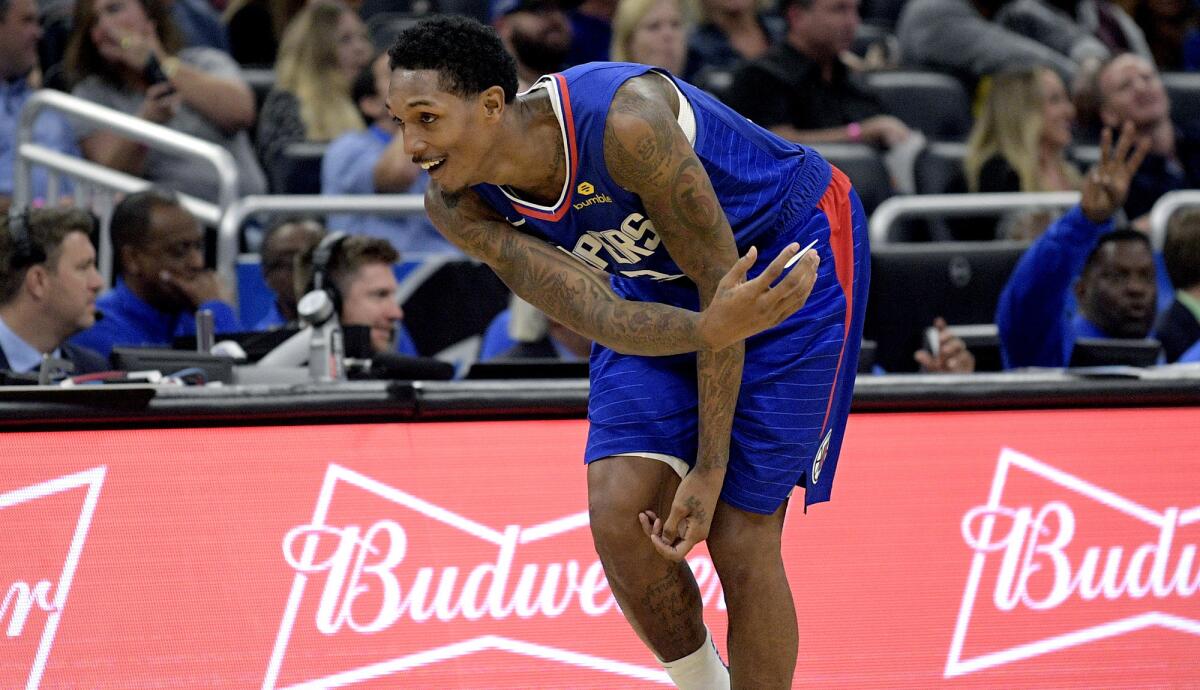 Clippers guard Lou Williams celebrates after making a long-range shot against the Magic in the fourth quarter on Friday night.