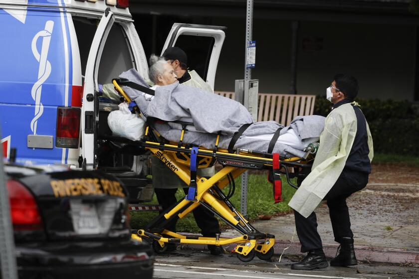 FILE - This April 8, 2020, file photo shows a patient being evacuated from the Magnolia Rehabilitation and Nursing Center in Riverside, Calif. California will help skilled nursing facilities wracked by the new virus by providing additional bed space for their patients on a Navy hospital ship and shipping masks and gloves for their workers, the governor said Friday, April 10. (AP Photo/Chris Carlson, File)