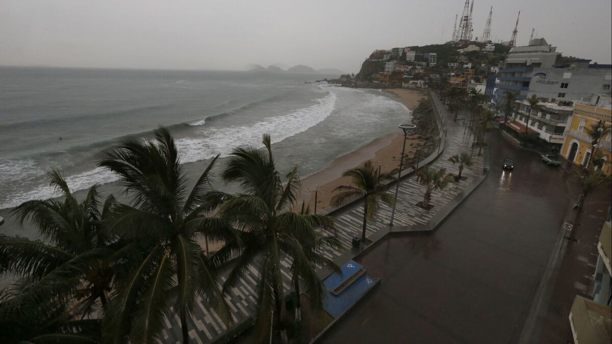 Rain began fall over Mazatlan's empty beaches as Hurricane Willa approached Tuesday evening. The hurricane hit land south of the Mexican resort town as a Category 3 storm.