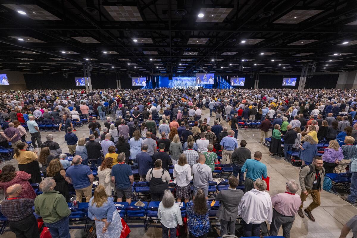 People stand for worship during a Southern Baptist Convention annual meeting in Indianapolis.