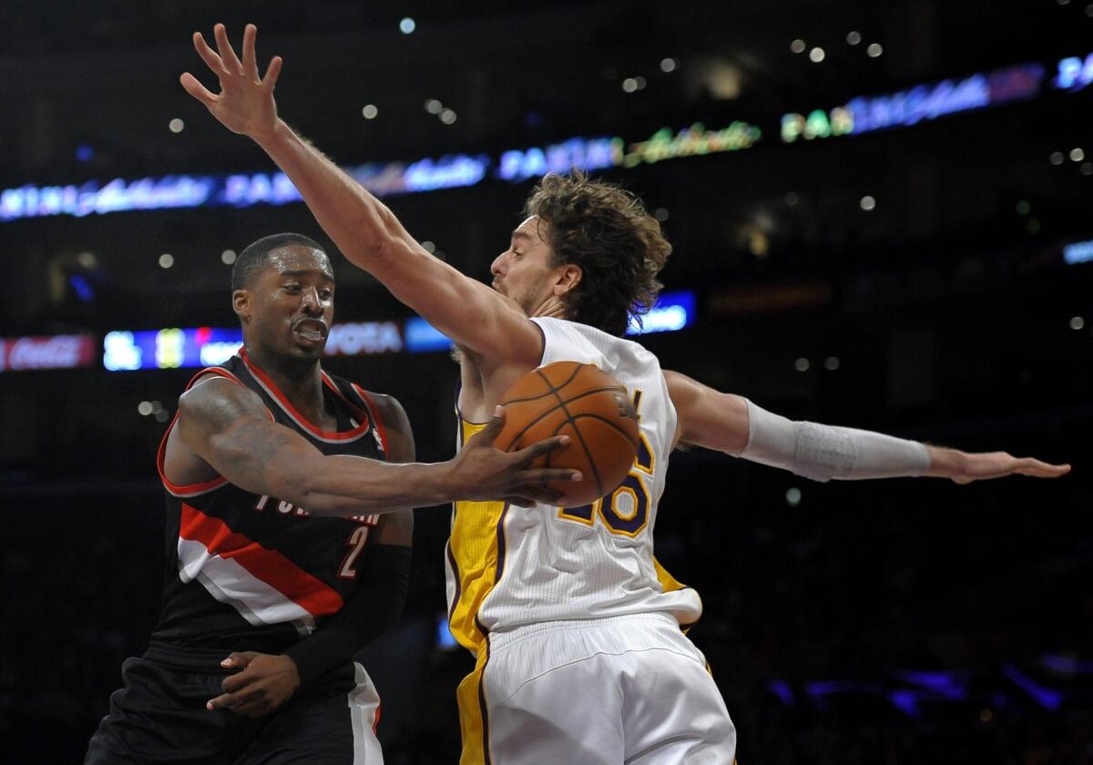 Portland Trail Blazers guard Wesley Matthews, left, passes behind Lakers forward Pau Gasol during the first half of Sunday's game at Staples Center.
