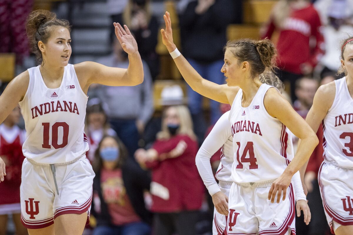 Indiana forward Aleksa Gulbe (10), left, and guard Ali Patberg (14) react as time expires in their overtime defeat of Maryland in an NCAA college basketball game, Sunday, Jan. 2, 2022, in Bloomington, Ind. (AP Photo/Doug McSchooler)