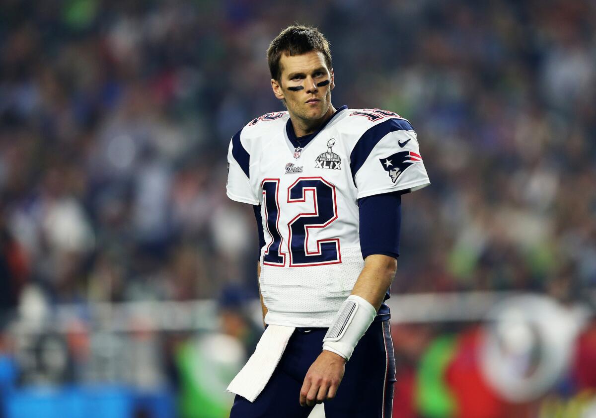 Tom Brady of the New England Patriots cheers as he runs on to the News  Photo - Getty Images