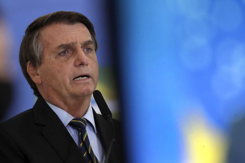 Brazil's President Jair Bolsonaro speaks at a ceremony announcing economic measures to support philanthropic hospitals and help them treat COVID-19 patients, at the Planalto Presidential Palace, in Brasilia, Brazil, Thursday, March 25, 2021. (AP Photo/Eraldo Peres)