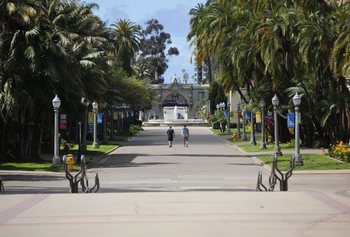 People walk down El Prado in Balboa Park on March 24, 2020. San Diego Mayor Kevin Faulconer closed all beaches and parks due to the coronavirus.