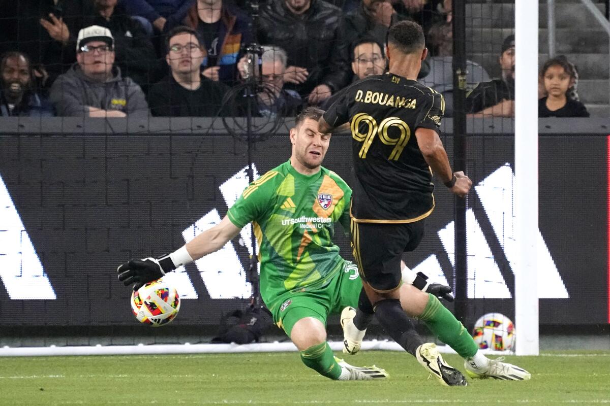 LAFC forward Denis Bouanga, right, scores on FC Dallas goalkeeper Maarten Paes at BMO Stadium.