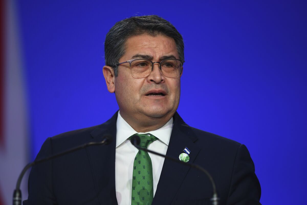 Honduras' President Juan Orlando Hernandez speaks during the opening ceremony of the UN Climate Change Conference COP26 in Glasgow, Scotland, Monday Nov. 1, 2021. The U.N. climate summit in Glasgow gathers leaders from around the world, in Scotland's biggest city, to lay out their vision for addressing the common challenge of global warming. (Andy Buchanan/Pool via AP)
