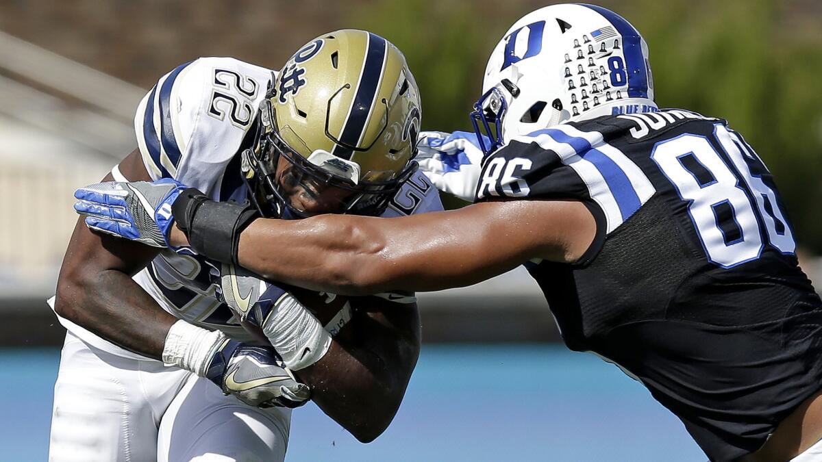 Pittsburgh running back Darrin Hall tries to break through the tackle attempt of Duke's Drew Jordan during a run in the first half Saturday.
