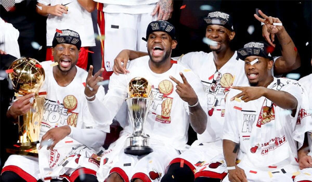 Dwyane Wade, LeBron James, Chris Bosh and Norris Cole celebrate the Heat's second consecutive NBA title after defeating the Spurs, 95-88, in Game 7.