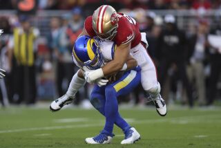 San Francisco 49ers defensive end Nick Bosa, top, sacks Los Angeles Rams quarterback Matthew Stafford 