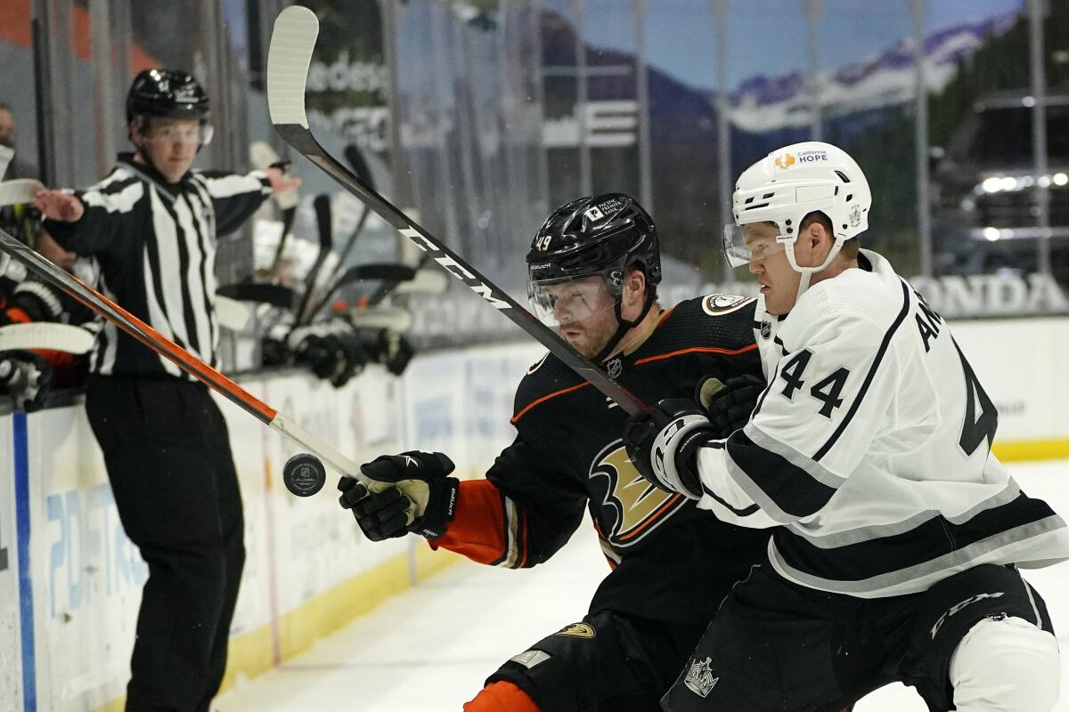 Ducks left wing Max Jones and Kings defenseman Mikey Anderson battle for the puck.